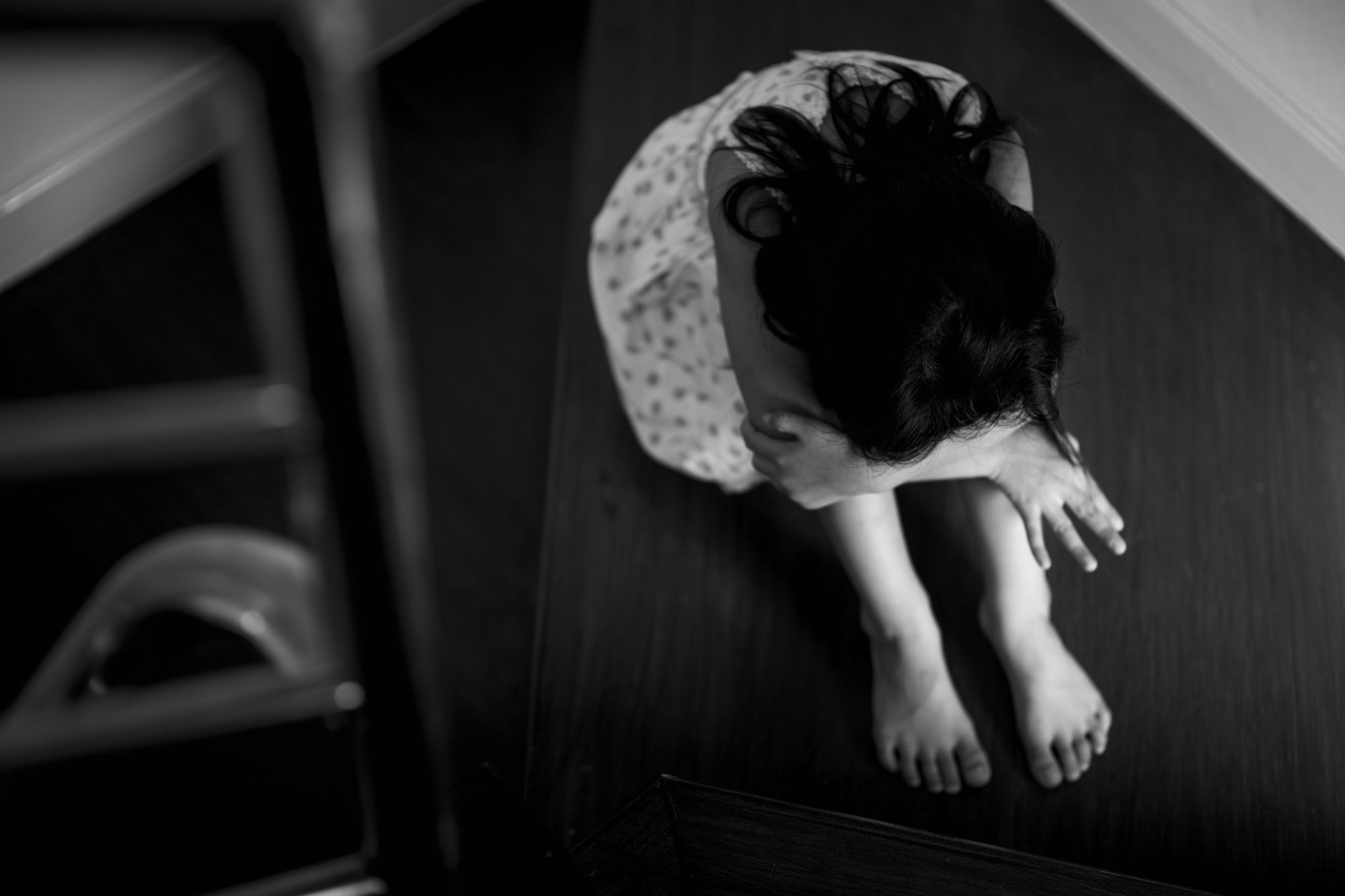 Child curled up asleep, illustrating disrupted sleep patterns